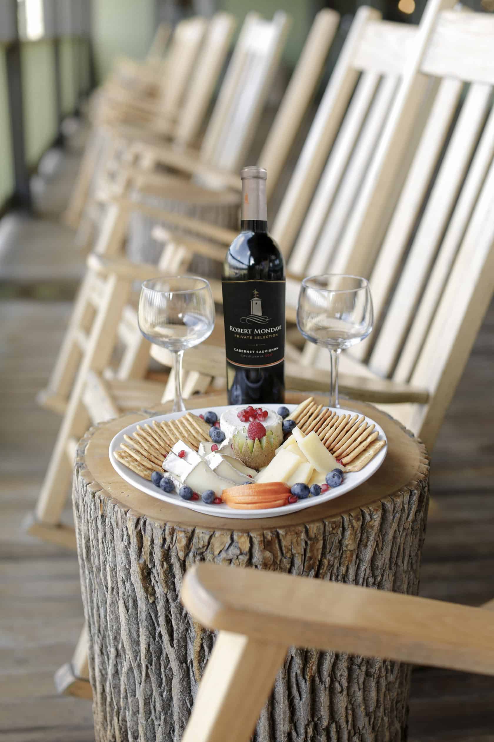 wine and cheese plate by rocking chairs