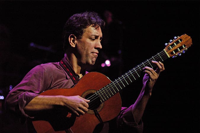 Portrait of David Gonzalez playing guitar on stage