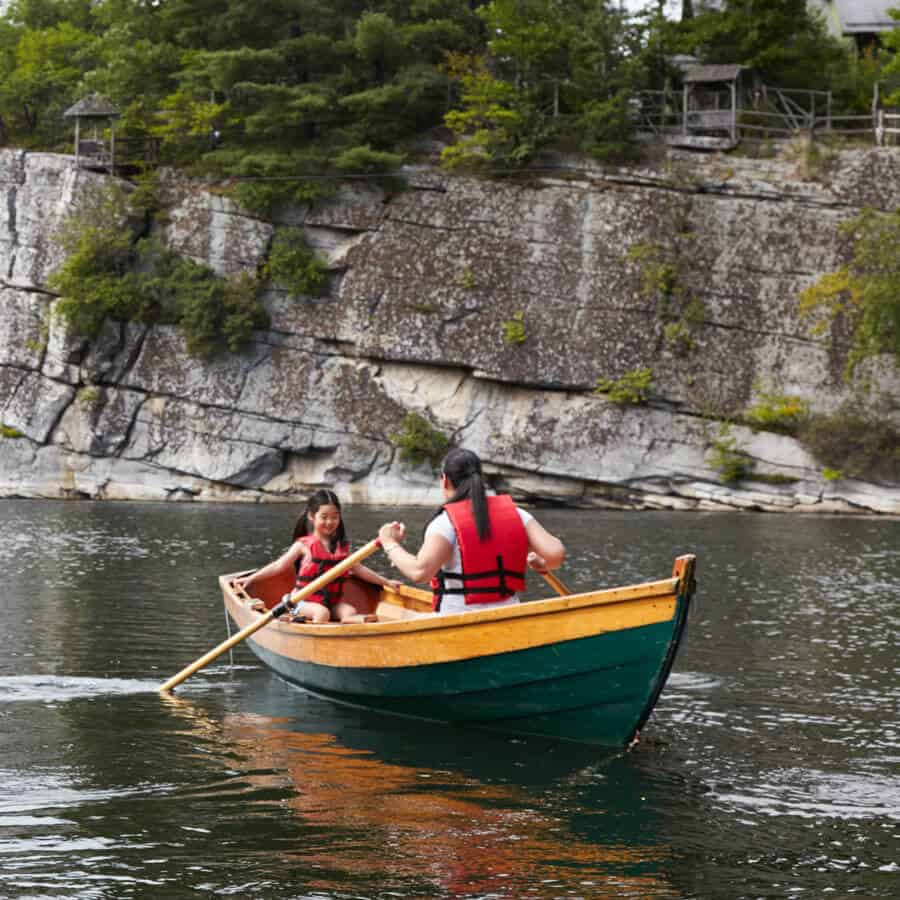 Family row boat on lake