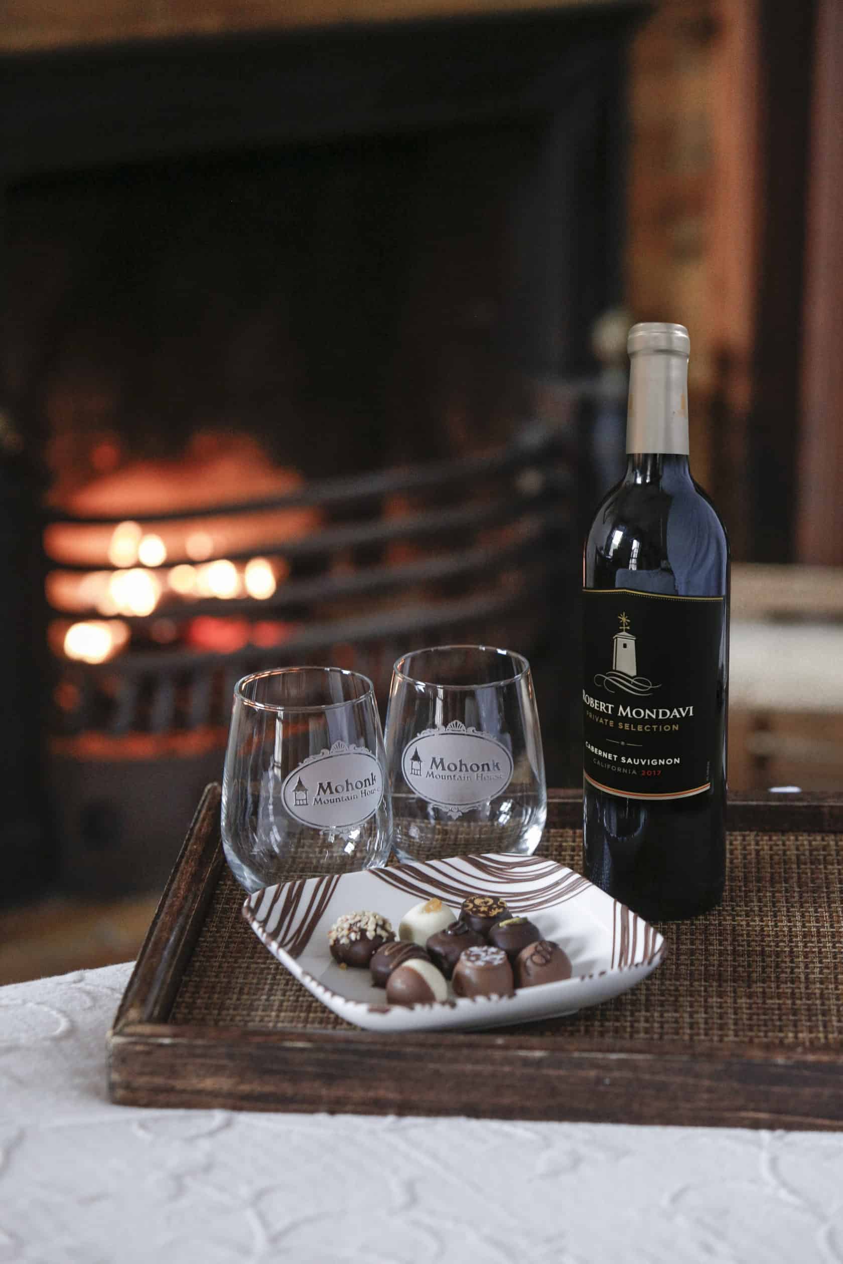 chocolates and wine by fireplace