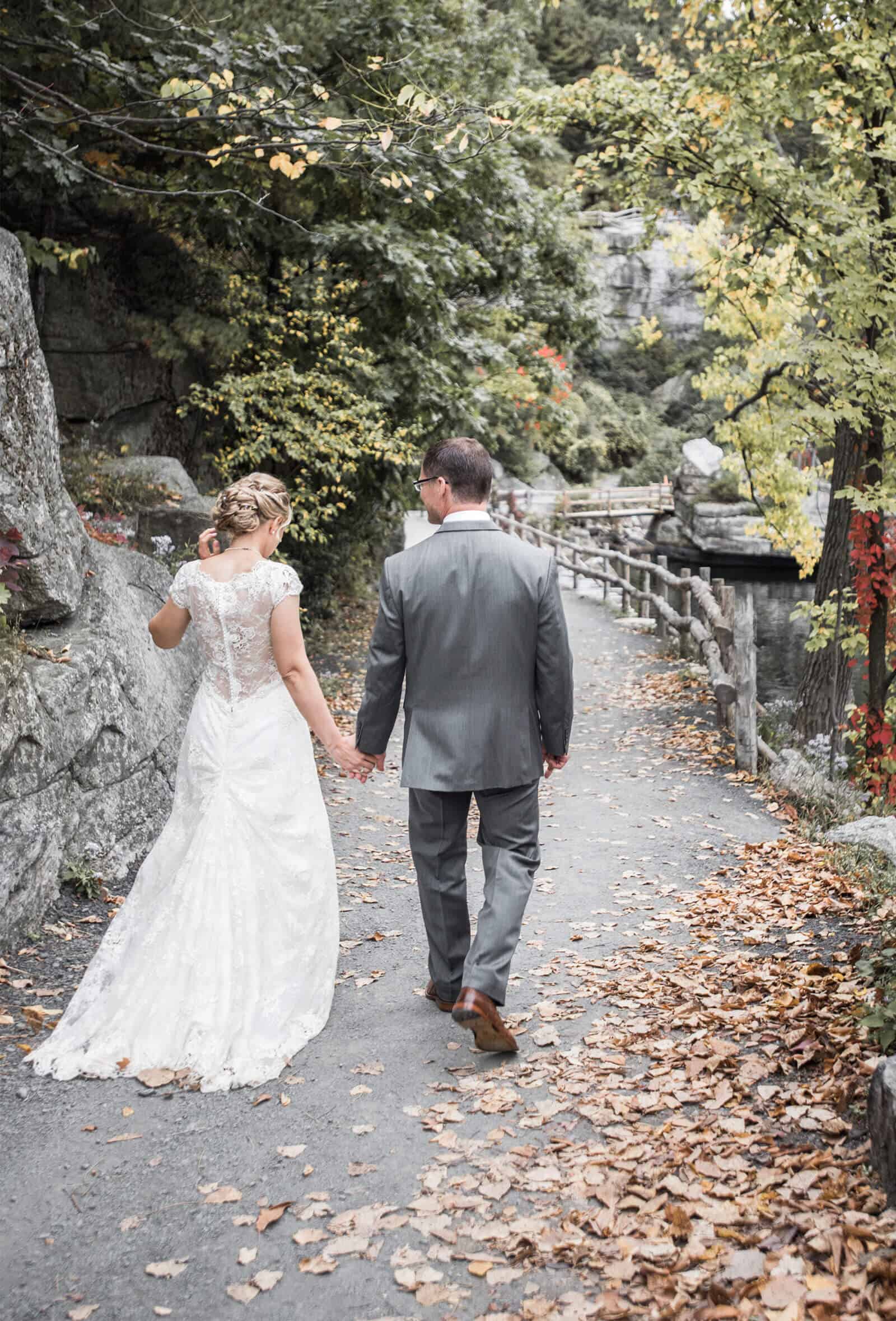 Bride and groom walking on trail